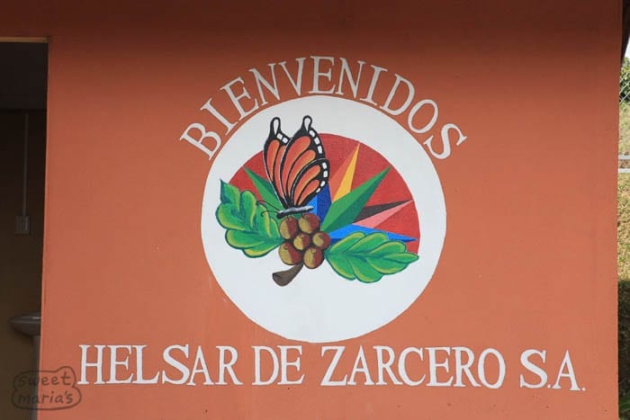 The "welcome" sign, hand-painted on the side of the Helsar de Zarcero micro mill in Costa Rica's West Valley coffee growing region.
