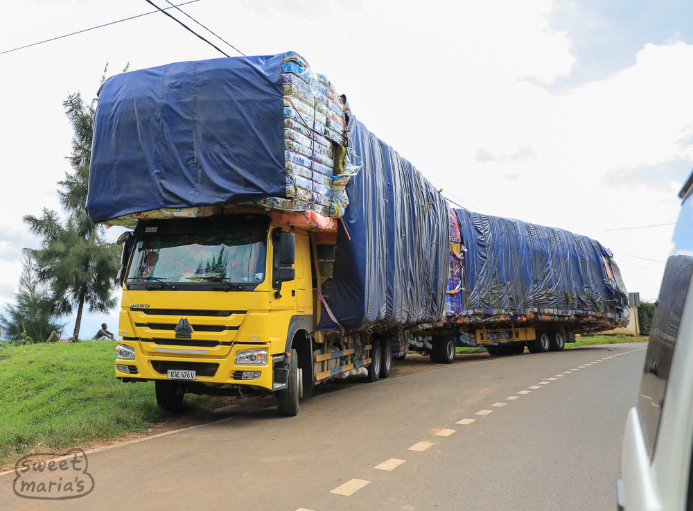 This truck was headed toward Uganda with an incredible load of matresses ... look under the beds and you see even more hanging down near the road surface! Wow.