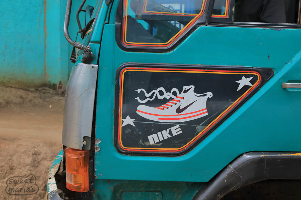Between stations, somebody and their favorite kicks. In fact this was a thing, the graphic of a sporty shoe on this specific lower window on the trucks. Rwanda style.