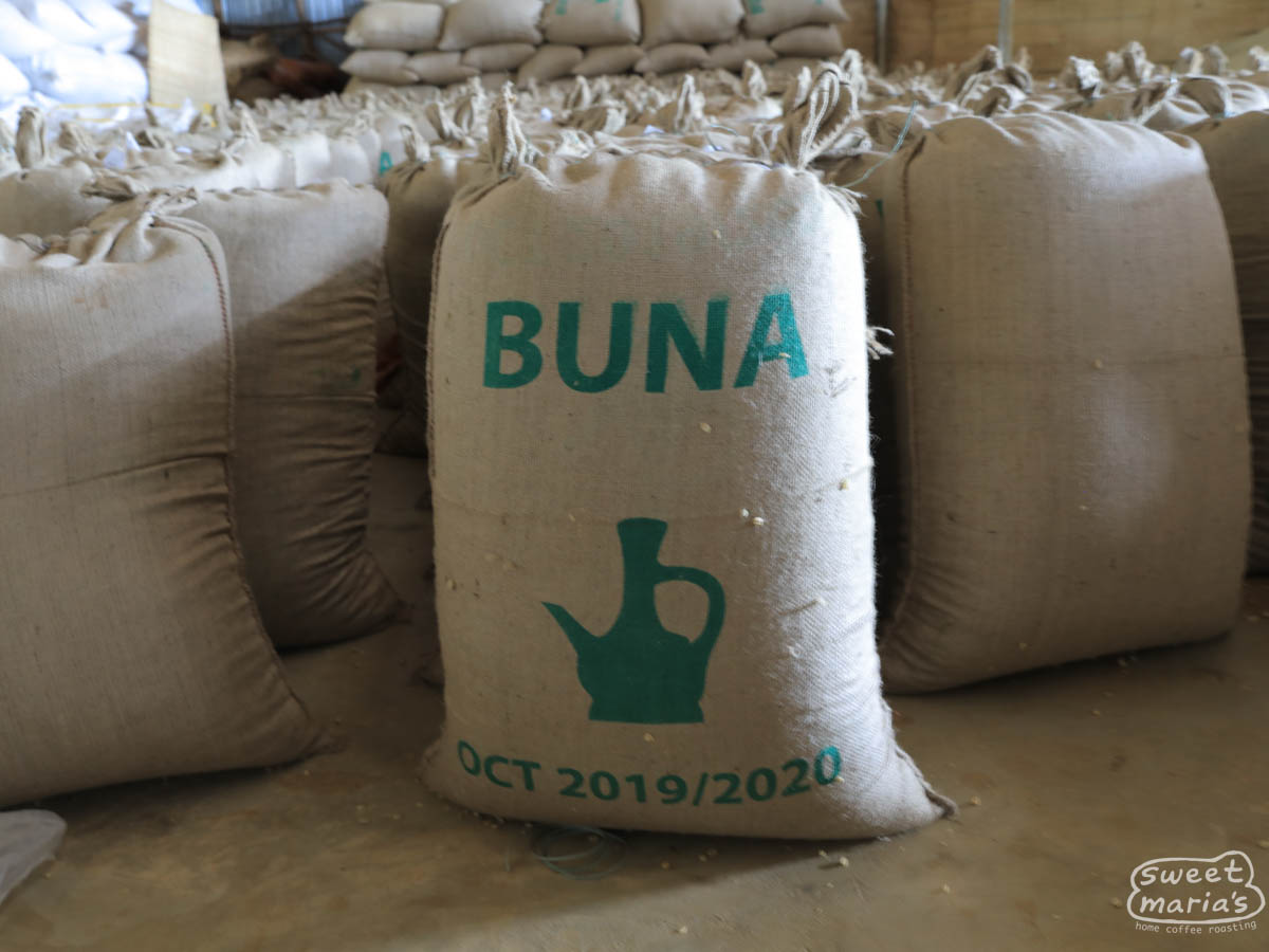 Jute fiber bags filled with dried parchment coffee are stored in a cool warehouse at Dame Dabaye wet mill in Hambela, Guji Zone.