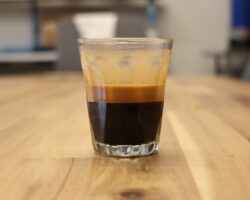 An espresso shot of Sweet Maria's Liquid Amber Blend in a glass espresso cup.