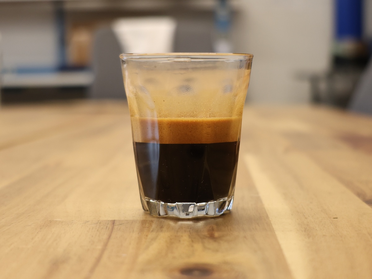 An espresso shot of Sweet Maria's Liquid Amber Blend in a glass espresso cup.